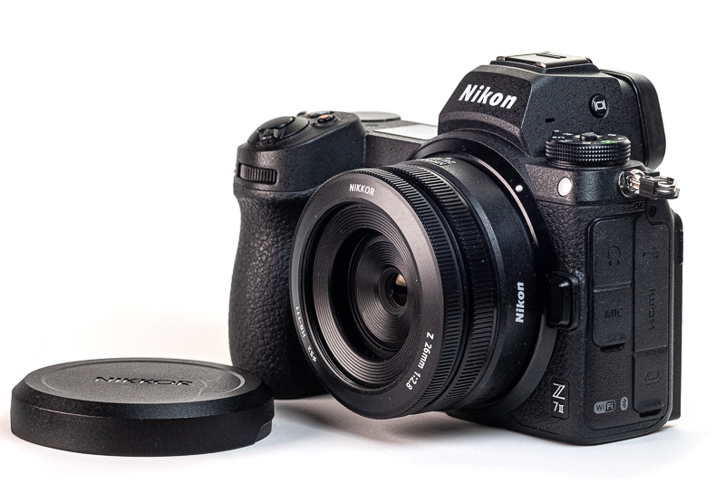 Nikon Z 26/2.8 with the hood attached on a Nikon Z 26